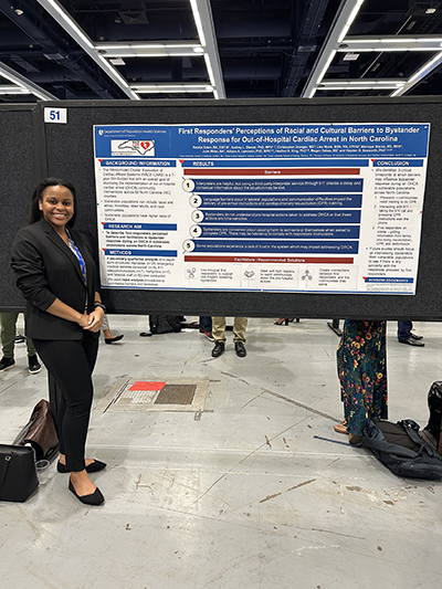 Natalie Ezem is shown standing proudly next to a poster presentation for the RACE-CARS study.