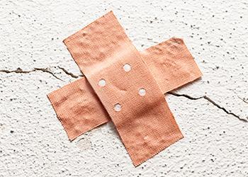 Two crossed band-aids