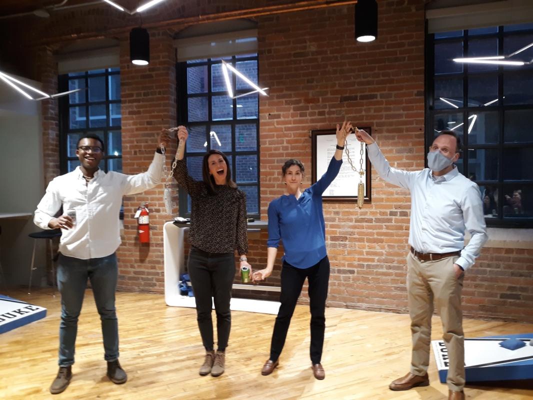 DEI Team Members Celebrating a Cornhole Game