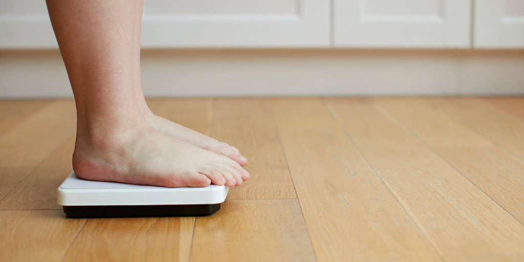 A picture of a person's feet as they weigh themselves