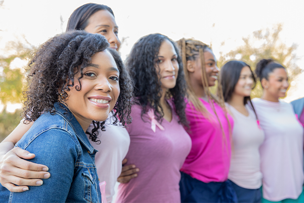 An image of women standing shoulder to shoulder 