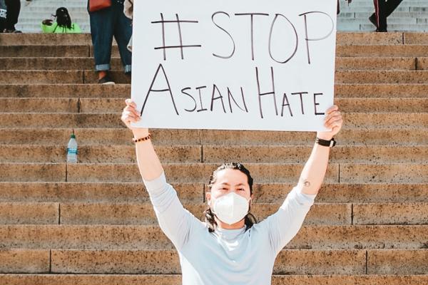 Person with sign saying Stop Asian Hate
