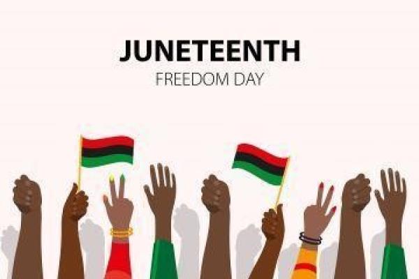 A picture of hands celebrating and waving Juneteenth flags with the text "Juneteenth Freedom Day" above them