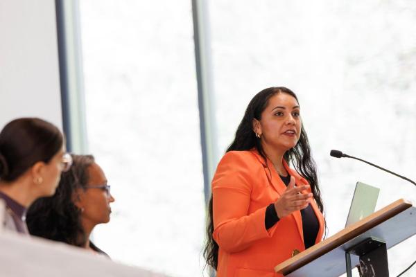 Elizabeth Rojo, doctoral student in population health sciences, speaking at the symposium