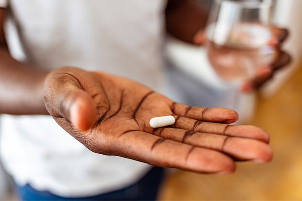 A picture of a patient holding a pill