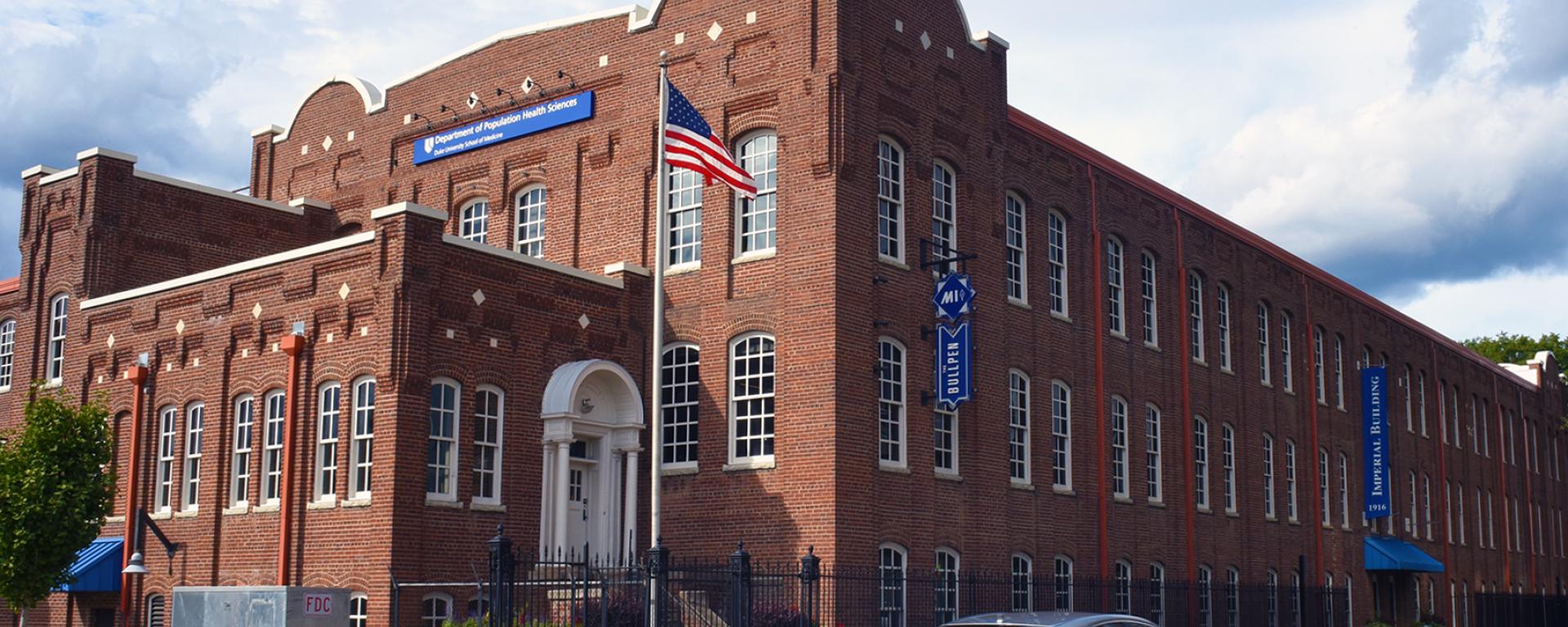 Exterior photograph of the beautiful, historic brick Imperial Building in Durham, home to the Department of Population Health Science.