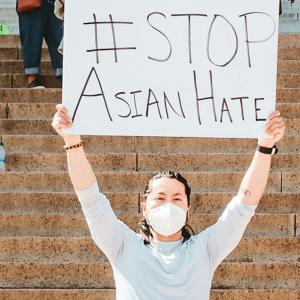 Person with sign saying Stop Asian Hate