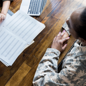 A veteran discussing paperwork with a person at a desk