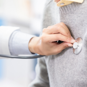 A doctor checking a patient's heartbeat
