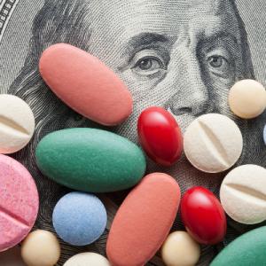 Stock photo of pills on a $100 bill