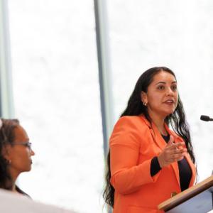 Elizabeth Rojo, doctoral student in population health sciences, speaking at the symposium